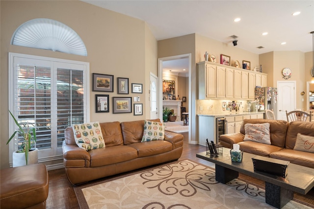 living room with wine cooler, recessed lighting, wood finished floors, and visible vents