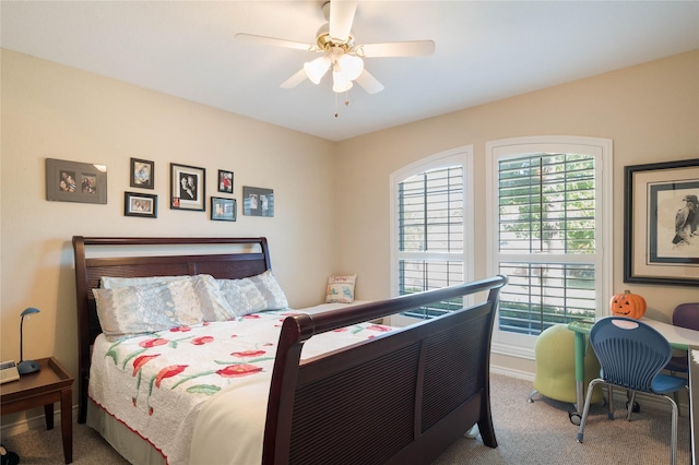carpeted bedroom featuring baseboards and ceiling fan