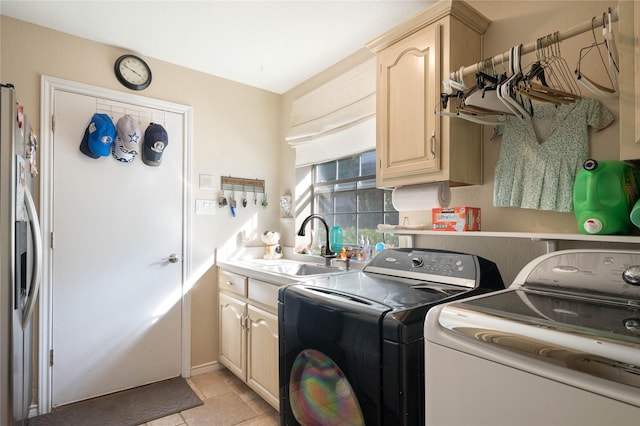 laundry room with cabinet space, a sink, and washer and clothes dryer