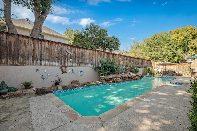 view of pool featuring a patio, a fenced in pool, and a fenced backyard