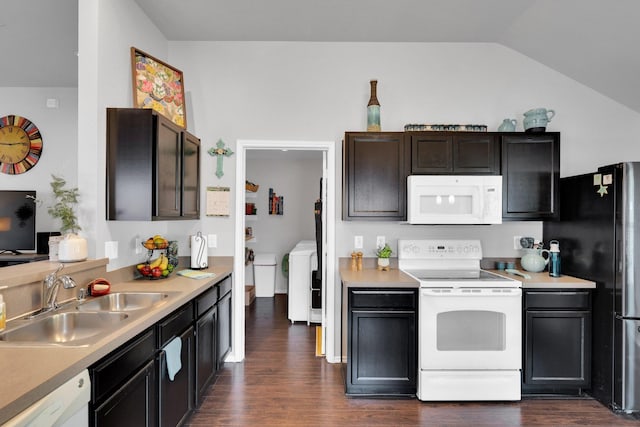 kitchen with white appliances, dark wood-style floors, light countertops, a sink, and vaulted ceiling