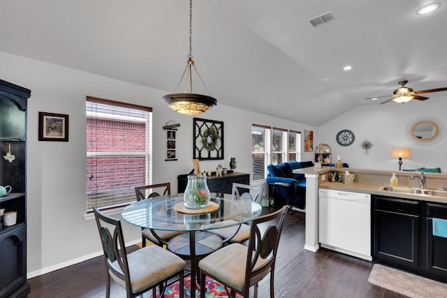 dining area featuring dark wood-style flooring, ceiling fan, visible vents, and vaulted ceiling