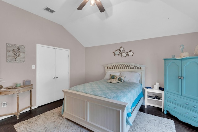 bedroom featuring visible vents, a ceiling fan, dark wood finished floors, and vaulted ceiling