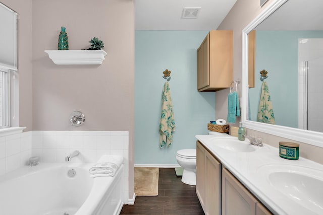 bathroom featuring visible vents, a sink, a garden tub, and wood finished floors
