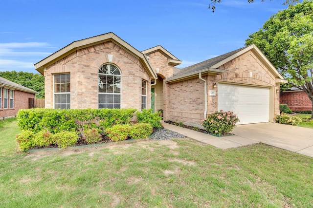 ranch-style house featuring brick siding, driveway, a front yard, and a garage