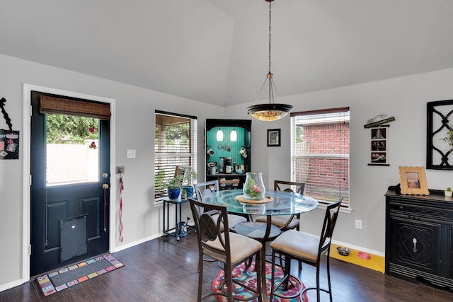 dining area with baseboards, dark wood-style flooring, a wealth of natural light, and vaulted ceiling