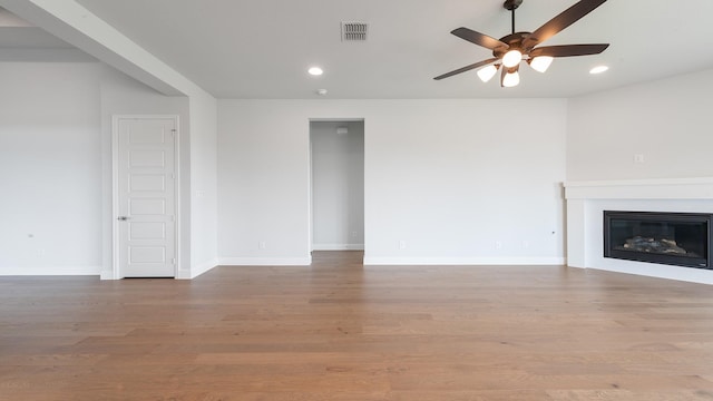 7313 Wayward Wind Dr, Fort Worth, TX 76179 - unfurnished living room featuring ceiling fan, recessed lighting, a glass covered fireplace, and wood finished floors