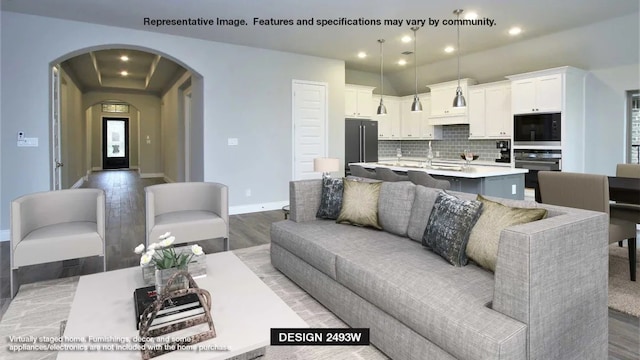 7313 Wayward Wind Dr, Fort Worth, TX 76179 - living area featuring light wood-style floors, arched walkways, baseboards, and recessed lighting