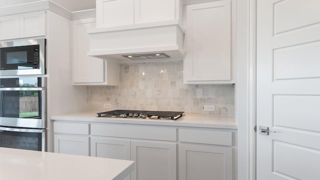 7313 Wayward Wind Dr, Fort Worth, TX 76179 - kitchen featuring stainless steel appliances, light countertops, tasteful backsplash, and white cabinetry