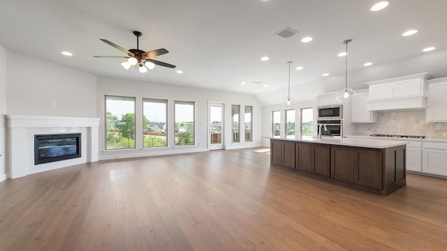 7313 Wayward Wind Dr, Fort Worth, TX 76179 - kitchen featuring open floor plan, stainless steel appliances, recessed lighting, light wood-style floors, and light countertops