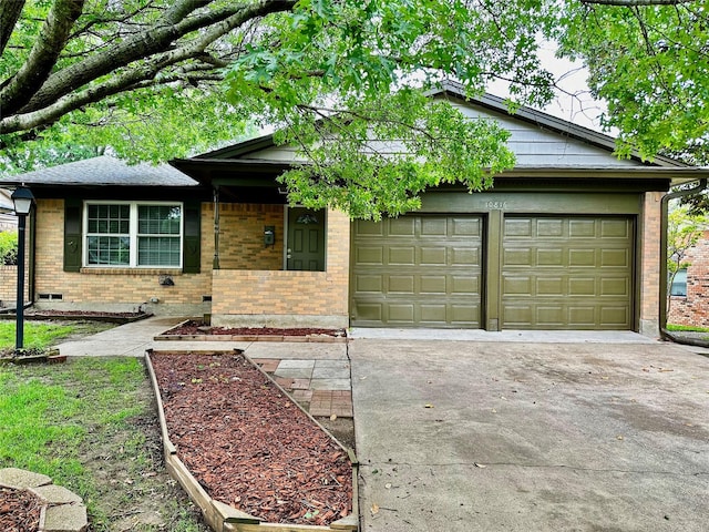 view of front of home with a garage, concrete driveway, and brick siding