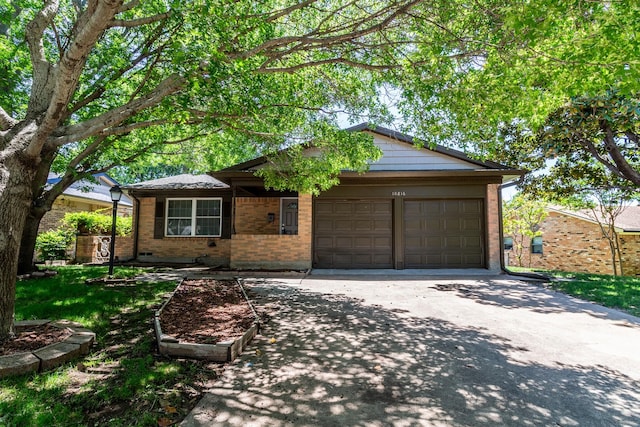 10816 Palace Way, Dallas, TX 75218 - single story home with brick siding, a garage, and driveway