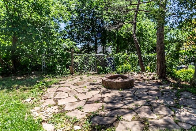 10816 Palace Way, Dallas, TX 75218 - view of patio / terrace with an outdoor fire pit and fence