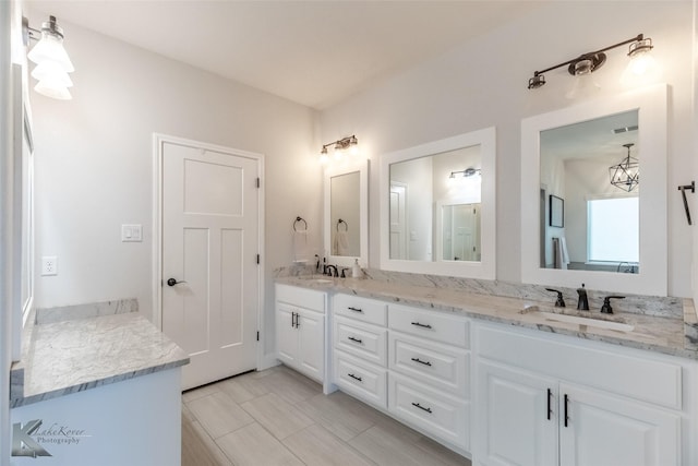 bathroom featuring double vanity and a sink