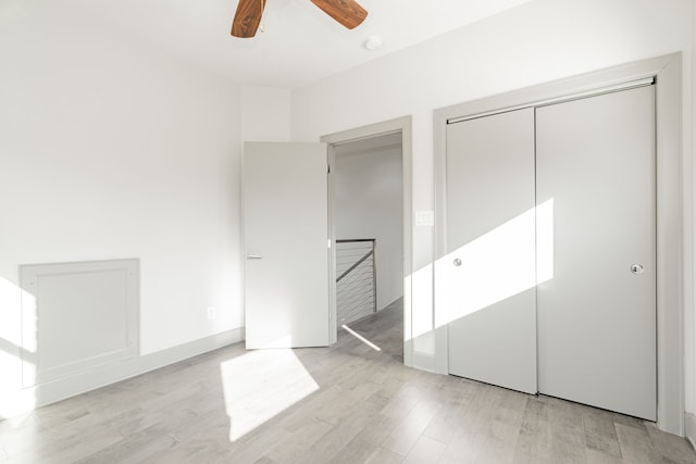 498 County Road 1952, Yantis, TX 75497 - unfurnished bedroom with a closet, a ceiling fan, and light wood finished floors