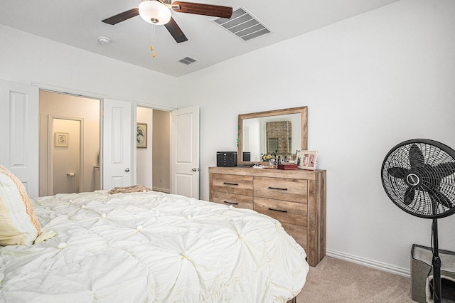 bedroom featuring baseboards, visible vents, light carpet, and ceiling fan