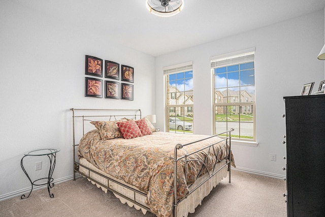 bedroom with carpet floors and baseboards
