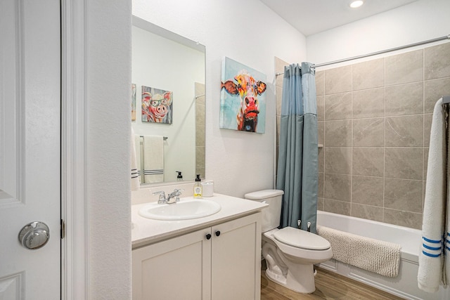 bathroom featuring vanity, wood finished floors, shower / bath combo, and toilet