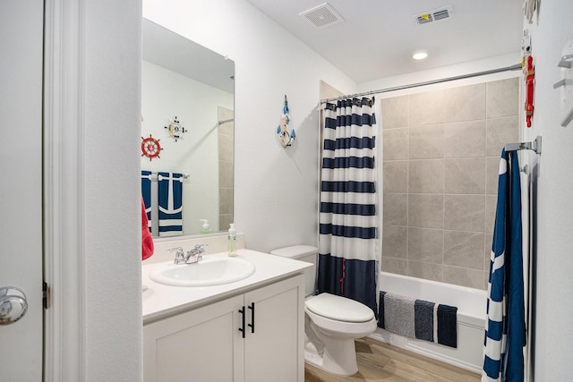 bathroom featuring visible vents, shower / bath combination with curtain, toilet, and vanity