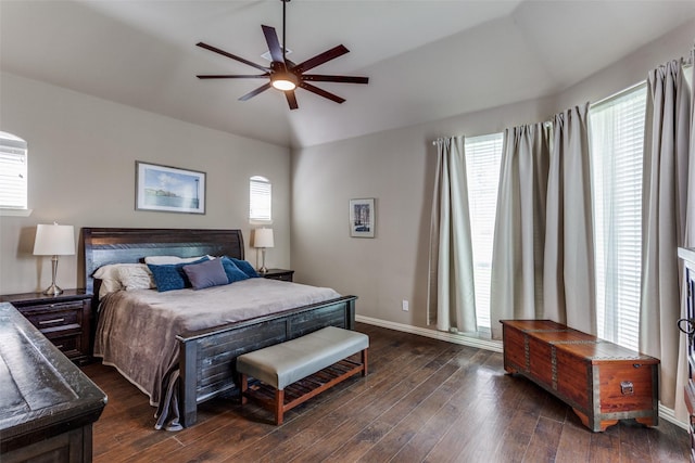 bedroom with baseboards, a ceiling fan, dark wood finished floors, and vaulted ceiling