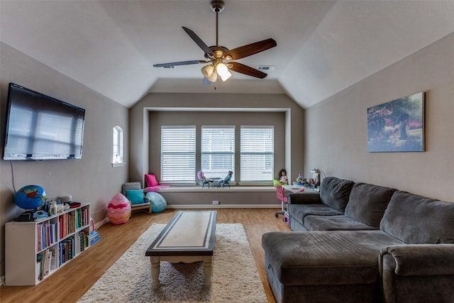 living room with visible vents, wood finished floors, lofted ceiling, baseboards, and ceiling fan