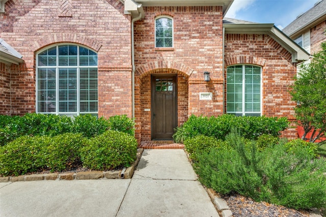 doorway to property with brick siding