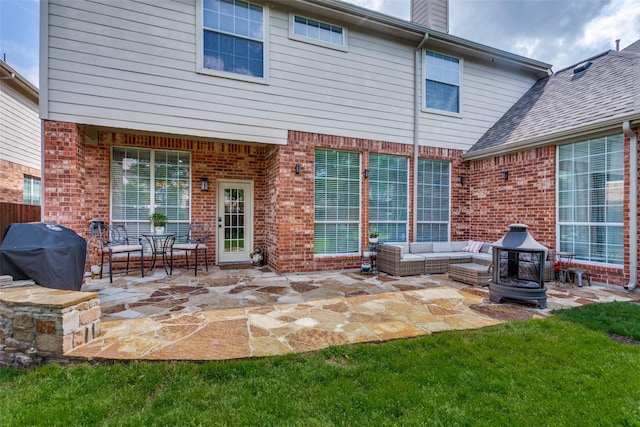 back of property featuring brick siding, a patio area, a chimney, and an outdoor hangout area