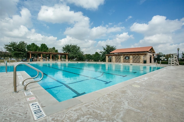 community pool featuring fence, a pergola, and a patio