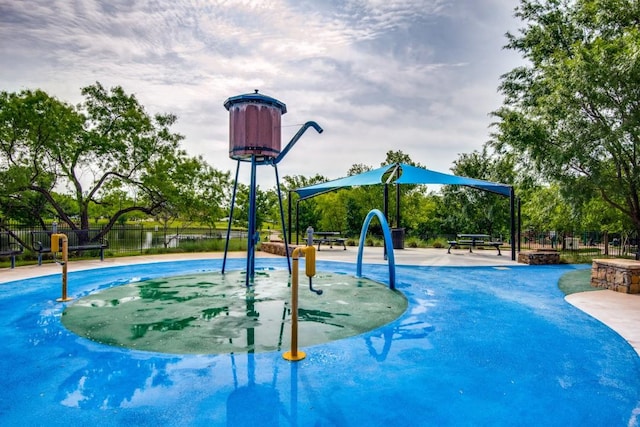 view of swimming pool featuring fence