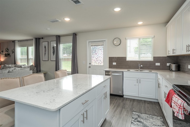 kitchen with visible vents, electric range oven, light stone countertops, dishwasher, and white cabinetry