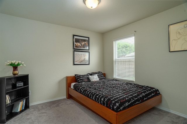 bedroom with carpet floors and baseboards