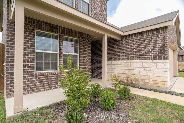 doorway to property featuring brick siding