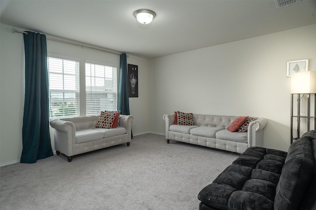 living area with baseboards and carpet