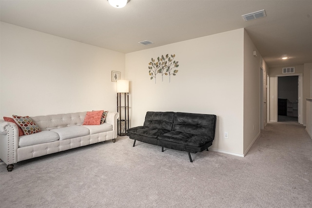 carpeted living area with baseboards and visible vents