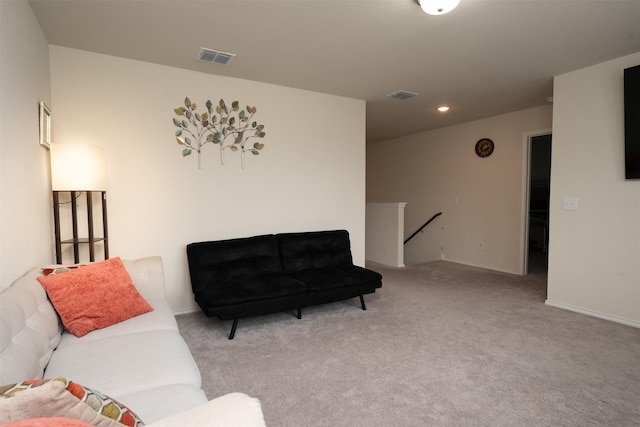 living area with visible vents, recessed lighting, baseboards, and light colored carpet