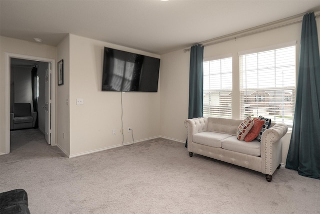carpeted living room featuring baseboards