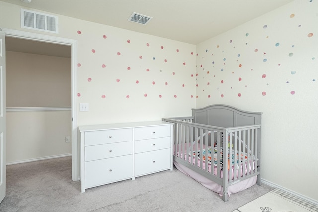bedroom featuring baseboards, visible vents, and light carpet
