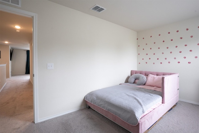 bedroom with baseboards, visible vents, and light carpet