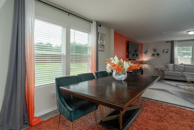dining room with baseboards and wood finished floors