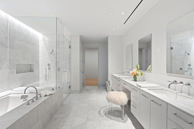 full bathroom with a bath, a sink, marble finish floor, and a stall shower