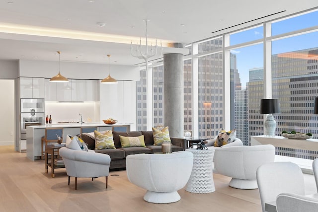 living room featuring light wood-style floors, a view of city, and expansive windows