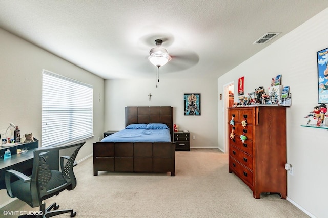 bedroom with visible vents, a ceiling fan, baseboards, and light carpet