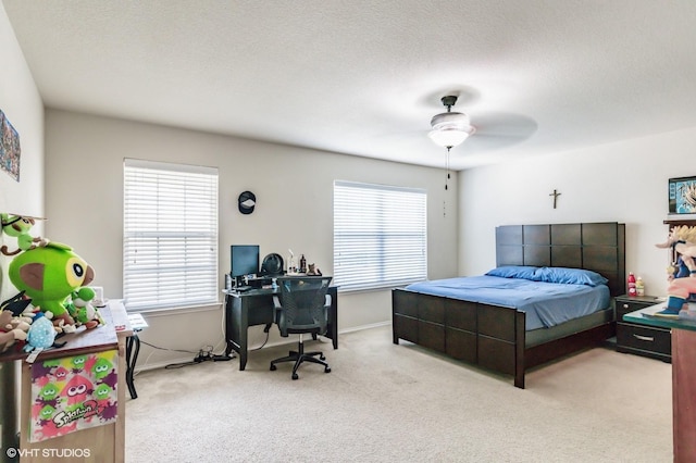 carpeted bedroom with baseboards and a ceiling fan