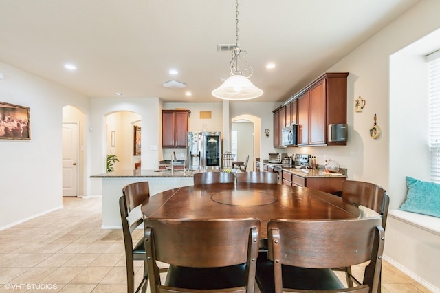 dining space with visible vents, arched walkways, light tile patterned floors, and recessed lighting