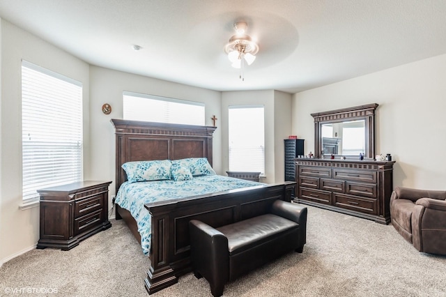 bedroom featuring multiple windows and light carpet