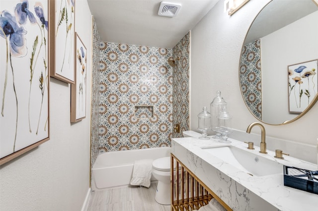 full bathroom featuring visible vents, shower / bathtub combination, toilet, and vanity