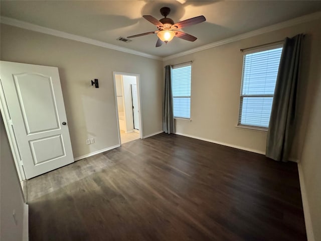 unfurnished room featuring visible vents, ornamental molding, baseboards, dark wood-type flooring, and a ceiling fan