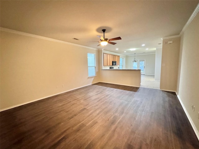 unfurnished living room with ornamental molding, baseboards, ceiling fan, recessed lighting, and dark wood finished floors