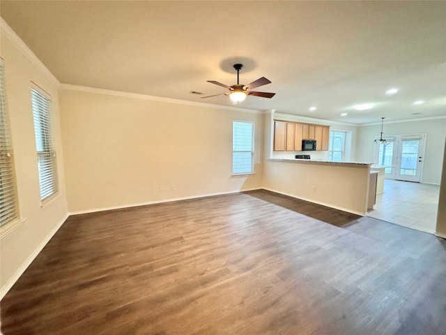 unfurnished living room featuring baseboards, ornamental molding, and dark wood-type flooring