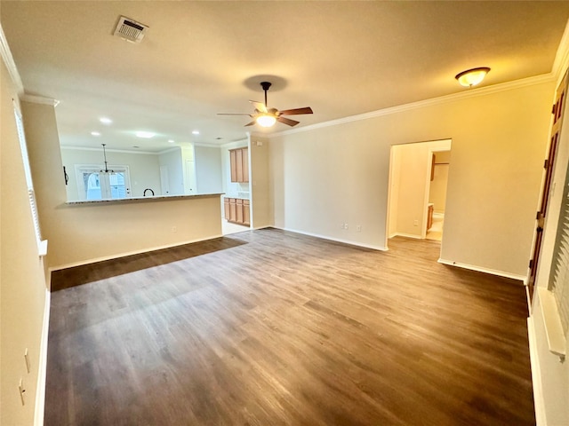 unfurnished living room with crown molding, baseboards, visible vents, and dark wood finished floors